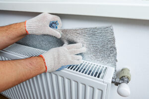 Installing reflective foil behind a radiator to avoid heat loss into the wall